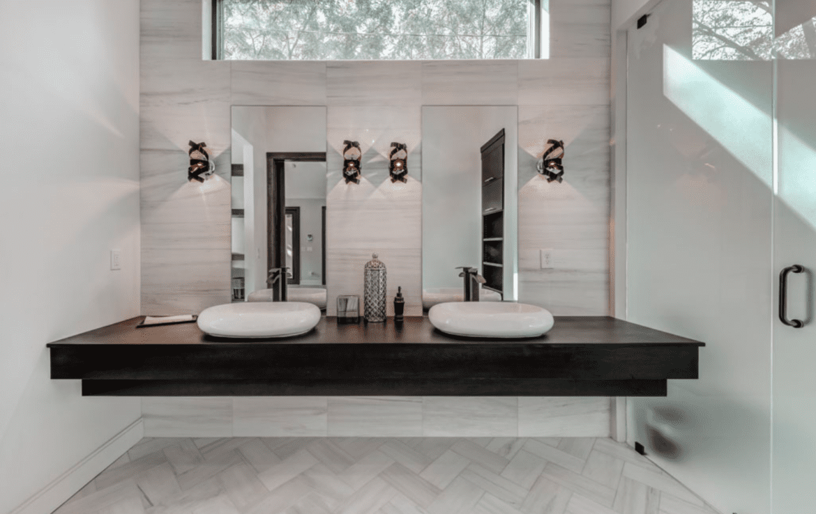 A modern bathroom with two sinks and a mirror.