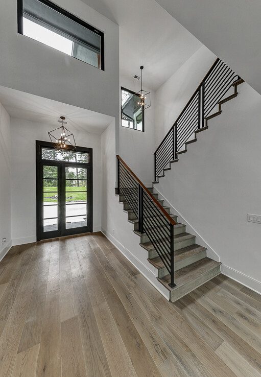 A modern home with wood floors and stairs.